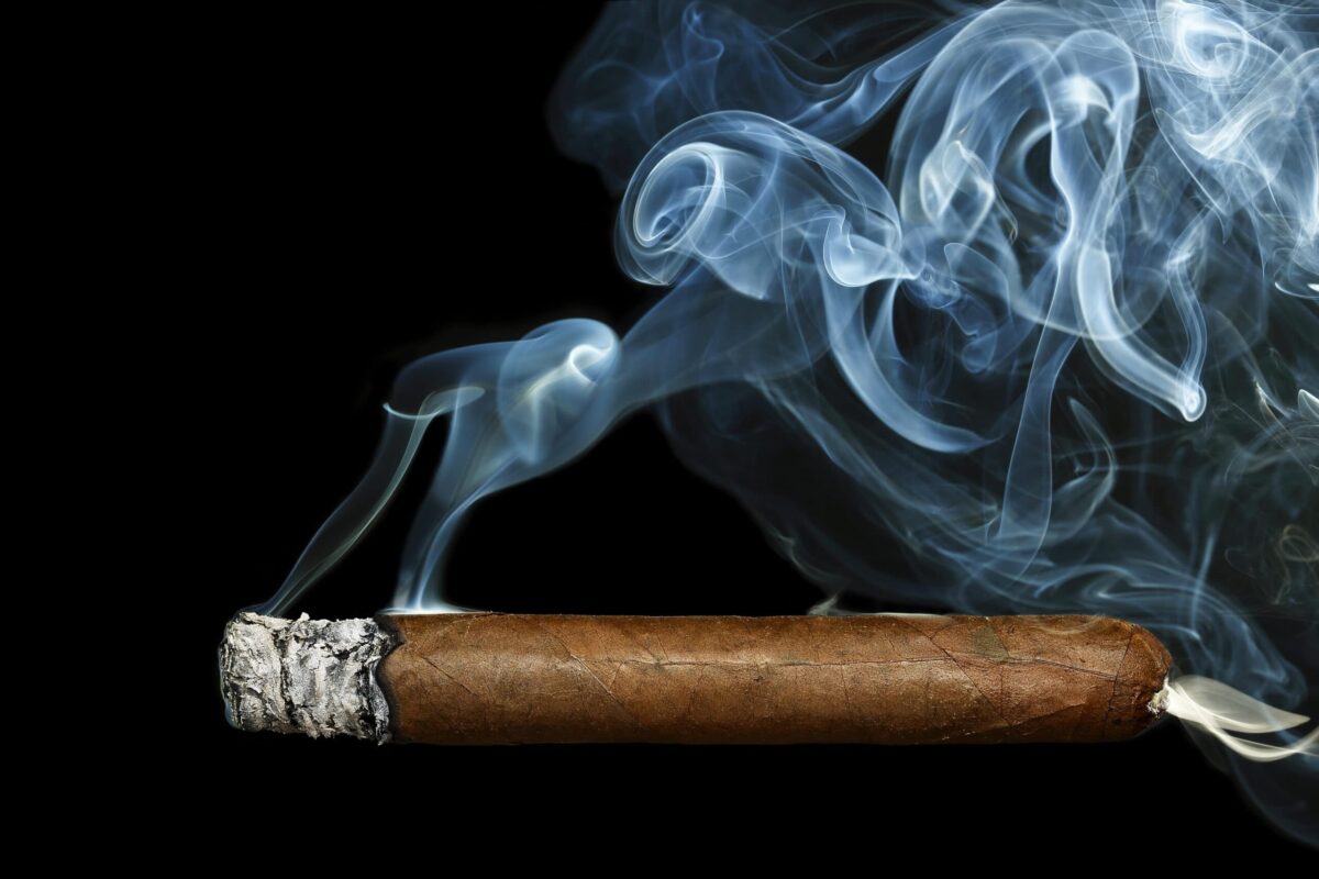 cigar with smoke on black background