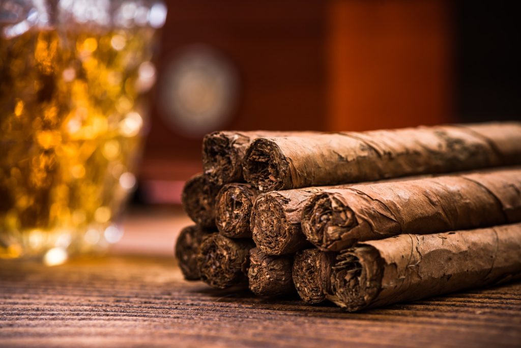 Cuban cigars on wooden table, close up detail